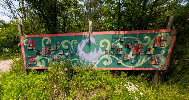 Adinkra symbols on a sign outside of an urban farm.